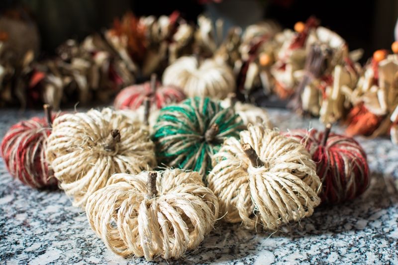 assorted diy pumpkins on a stone hearth